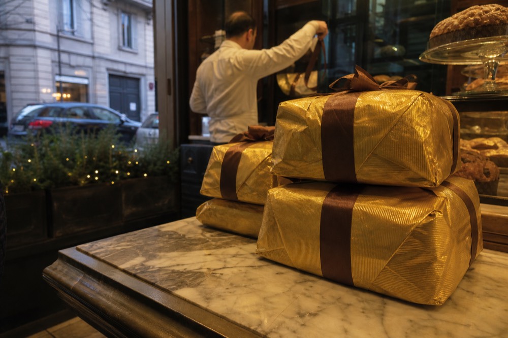 A pastry shop counter filled with boxed panettone cakes at Christmas