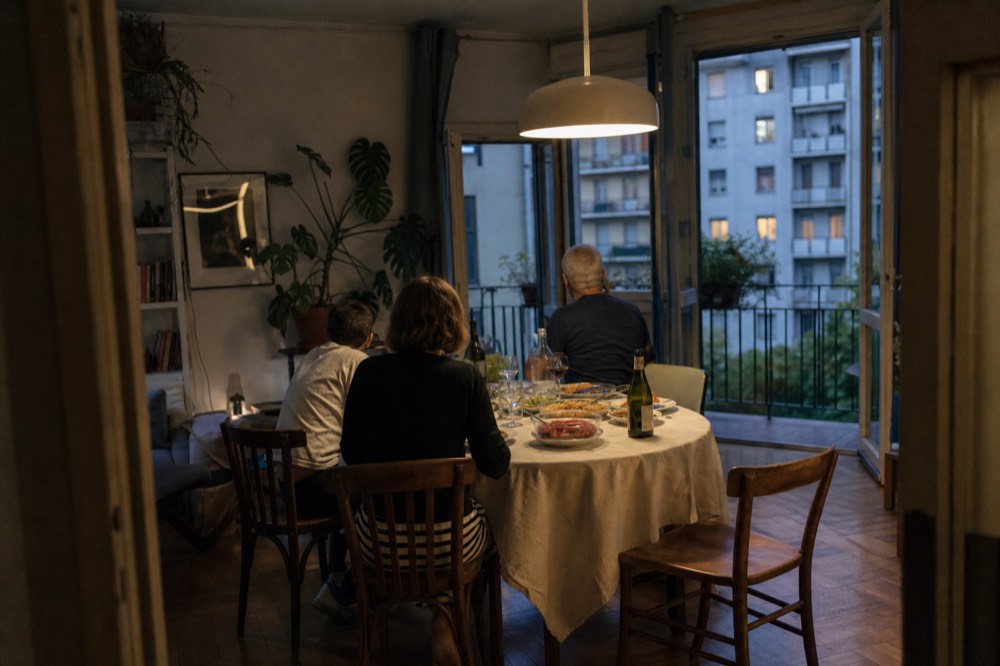 A family dining table set for dinner with shared dishes of home-cooked food