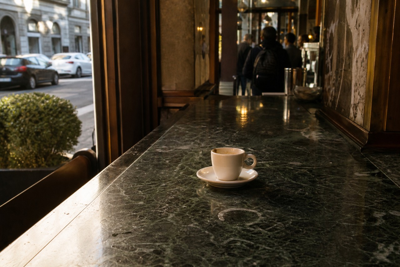 Marble bar counter of a historic Milan cafe with an espresso cup and saucer