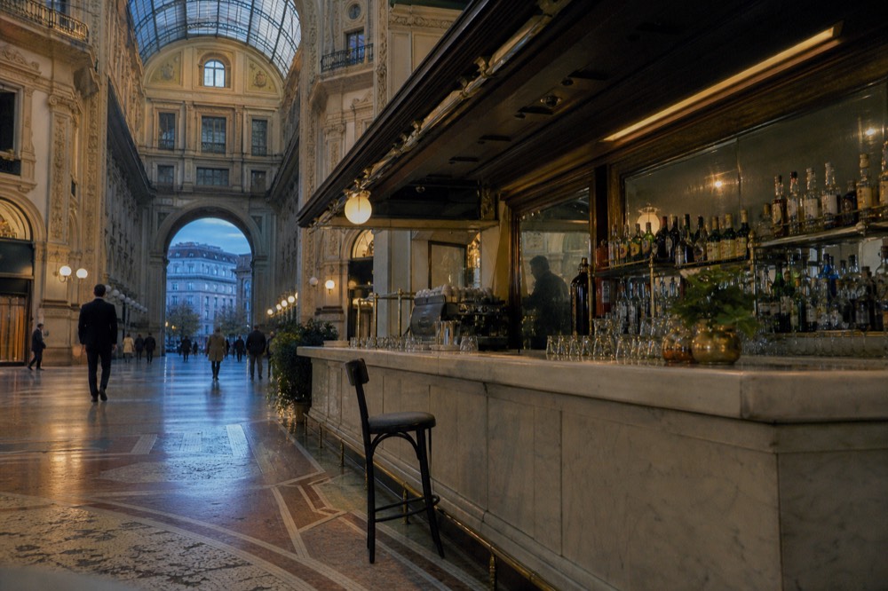 Historic bar interior with brass fittings and a long marble counter in the Galleria