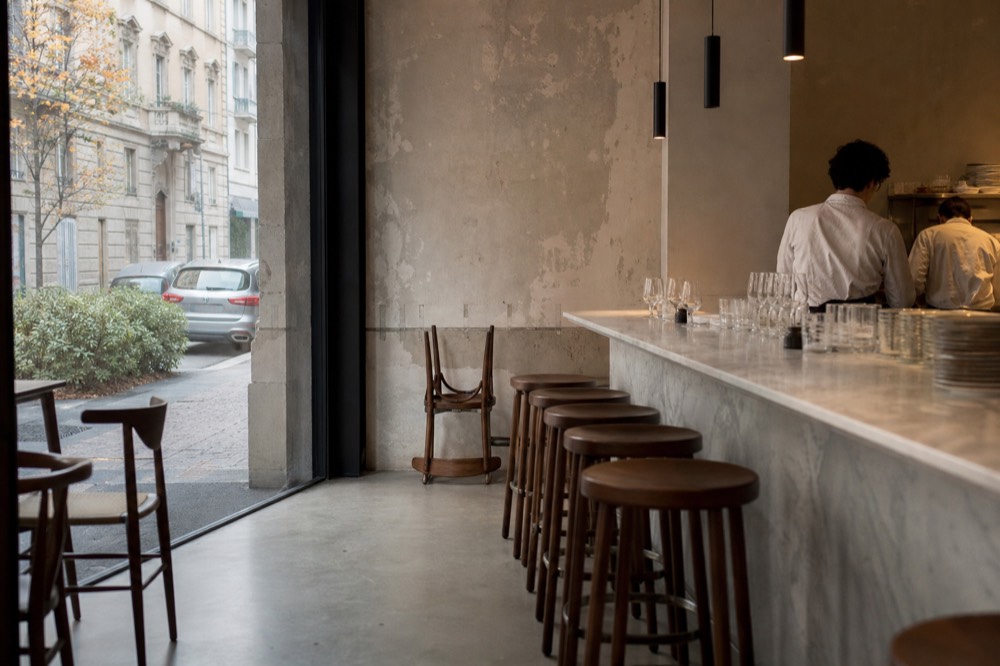 Newly opened restaurant interior with marble counter and empty stools
