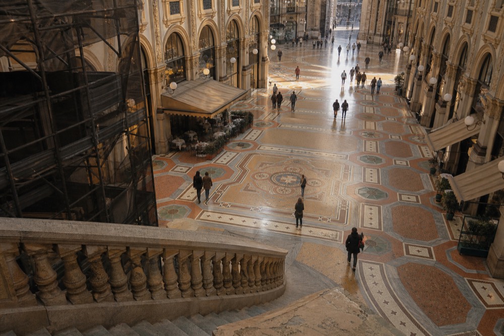 Glass vaulted arcade of the Galleria Vittorio Emanuele II with mosaic floor and shopfronts