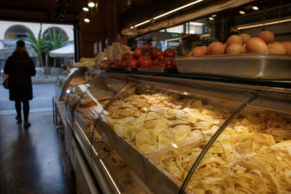 Close-up of a food stall with fresh pasta and ingredients on display