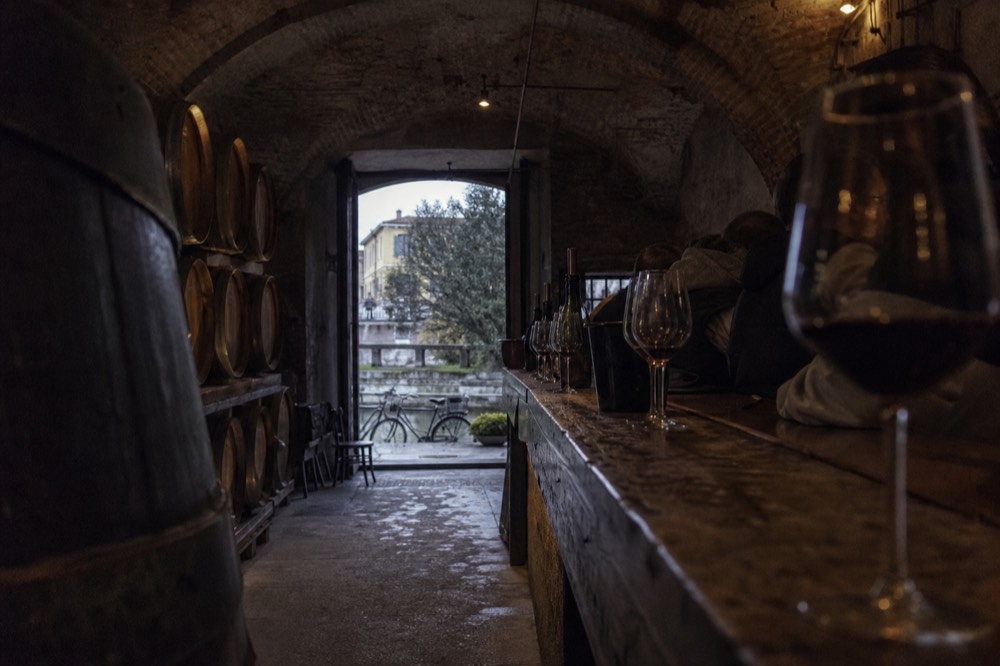 Oak barrels and tasting counter inside an urban wine cellar