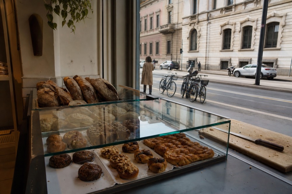 A gluten-free bakery display case with breads and pastries