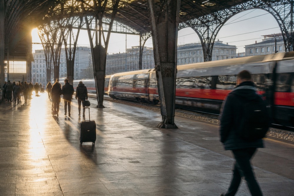 A train platform at Milano Centrale station in morning light
